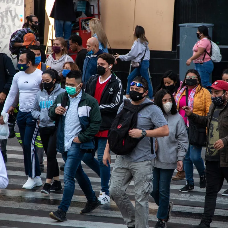 people in the streets of mexico wearing masks