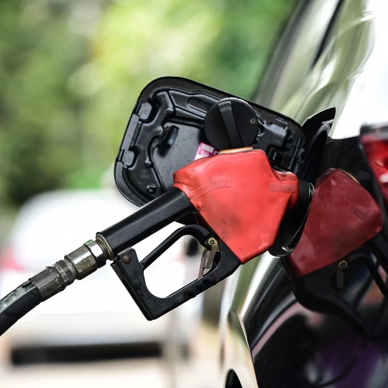 gas pumping in black car