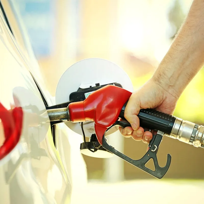 gas pumping in white car