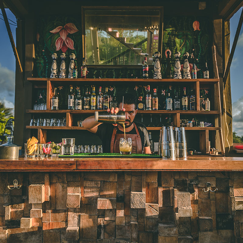 Bartender pouring tequila cocktail