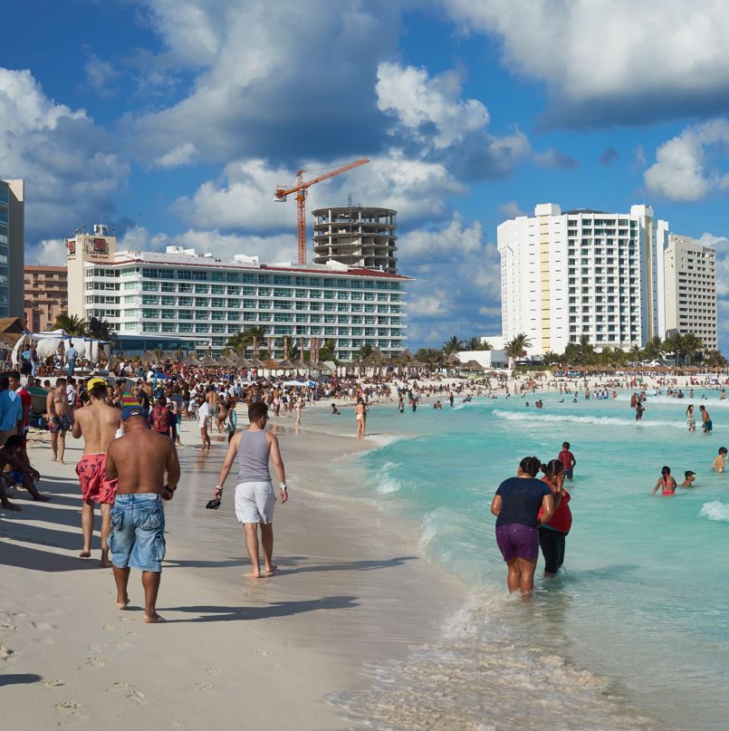 Cancun tourists on beach near hotel zone 