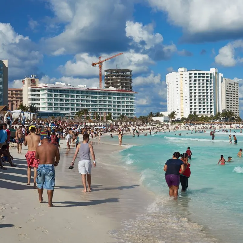 Cancun tourists on beach near hotel zone