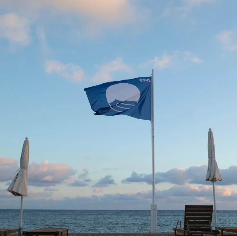 A blue flag NGO flag on the beach