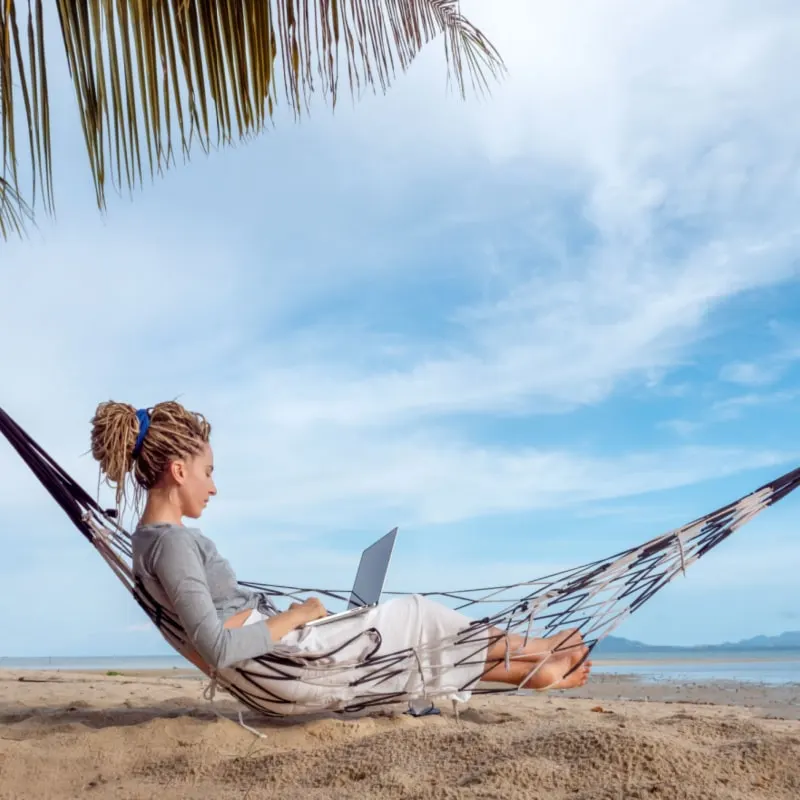 digital nomad working on the beach