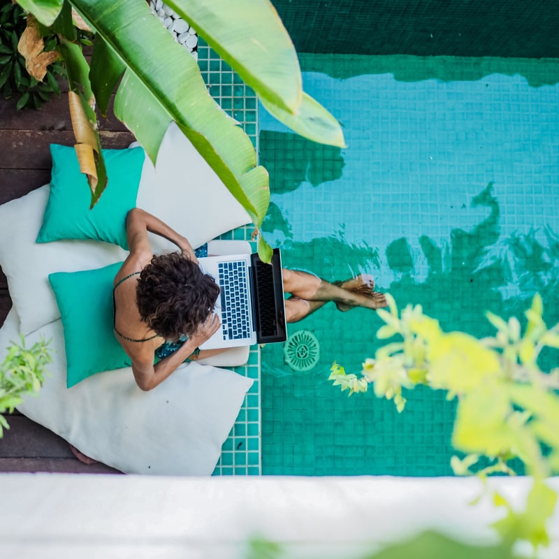 woman using notebook on the pool