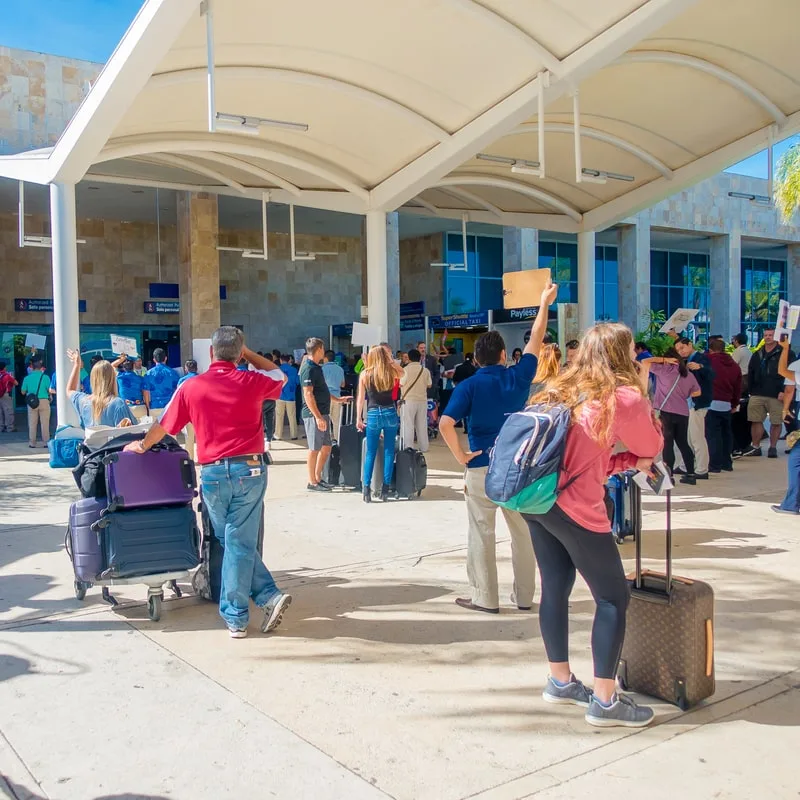 passengers in front of cancun's airport