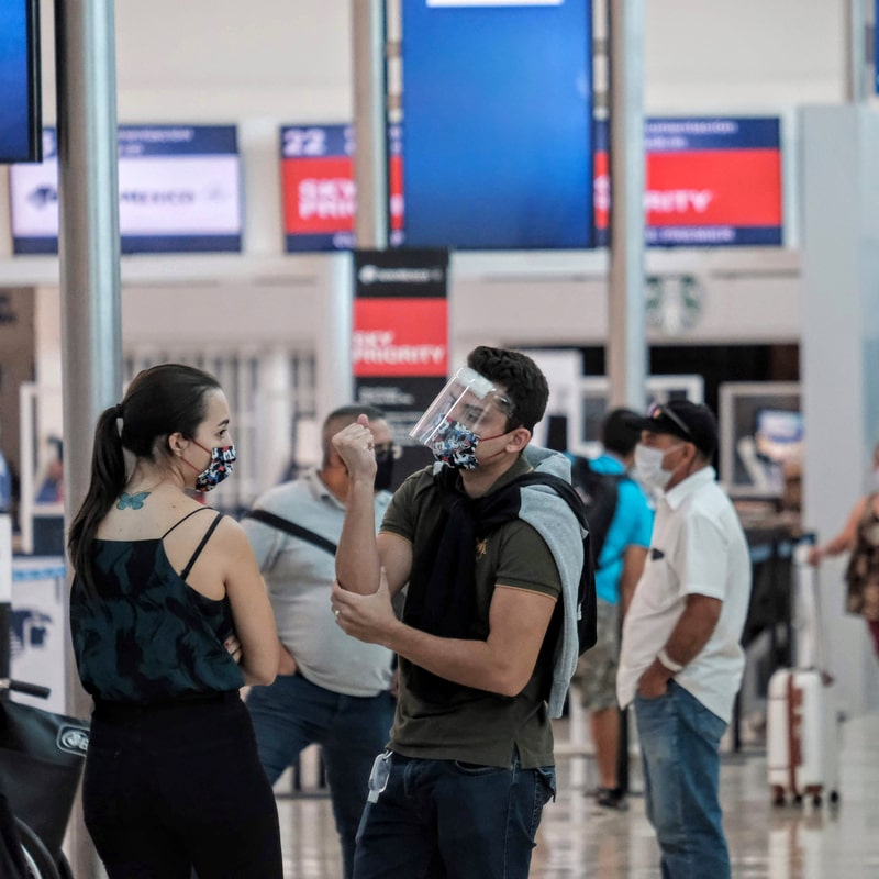 passengers wearing mask at cancun airport
