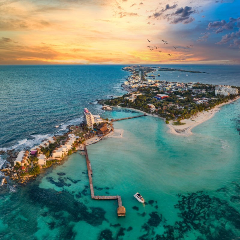 Aerial view of Cancun and Isla Mujeres at sunset.