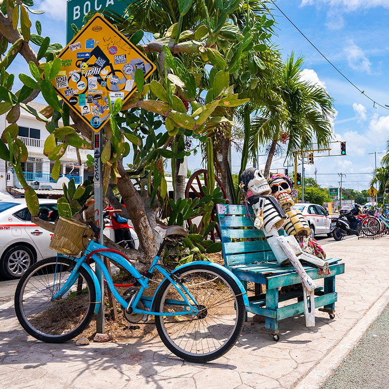 bike parked on busy street in Tulum 