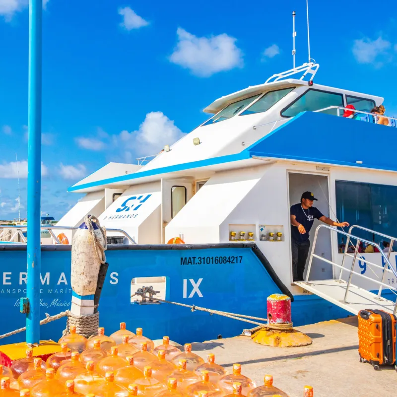 Ferry boat in Cancun with a man waiting for luggage to be loaded