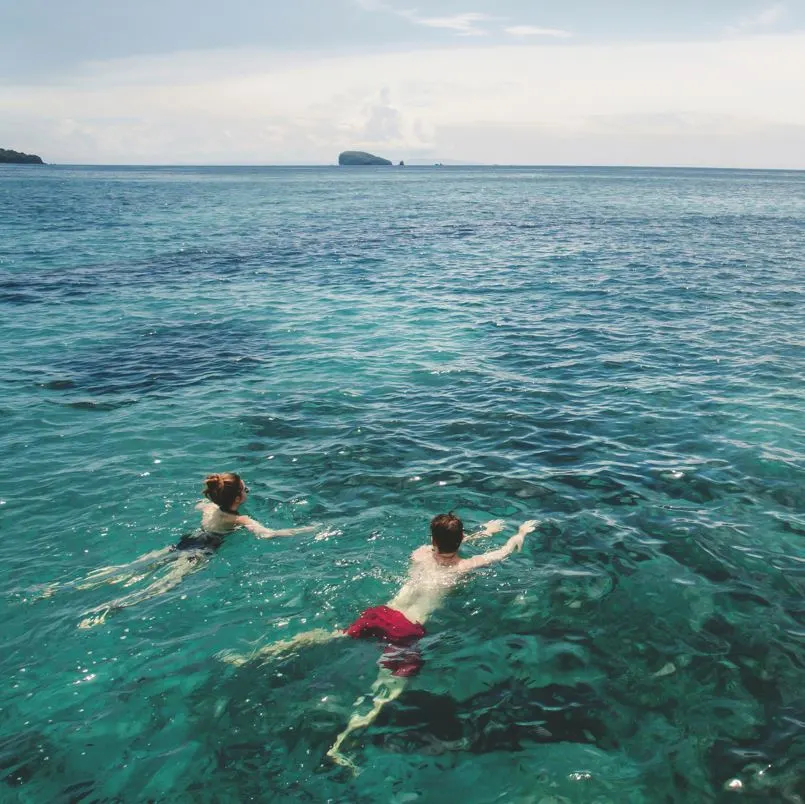Tourists Swimming In Sea 