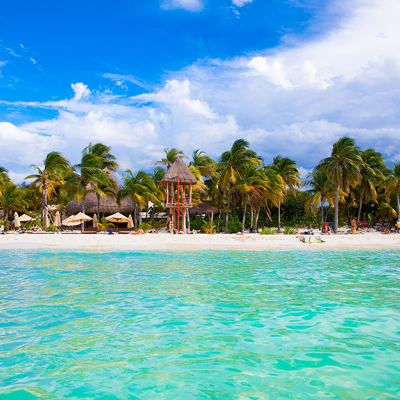 Playa Norte Isla Mujeres beach with tourists playing in the sand