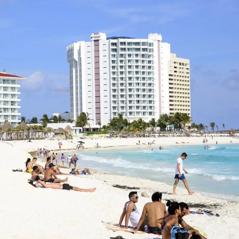 Tourists enjoying the beautiful beaches of Cancun.