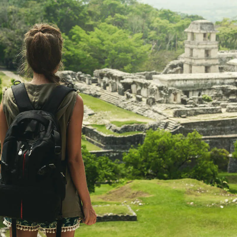 girl looking at maya ruins