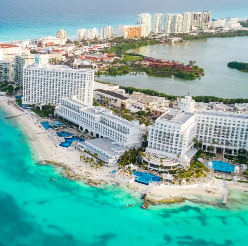 Cancun aerial photo of buildings and beaches with turquoise blue water.