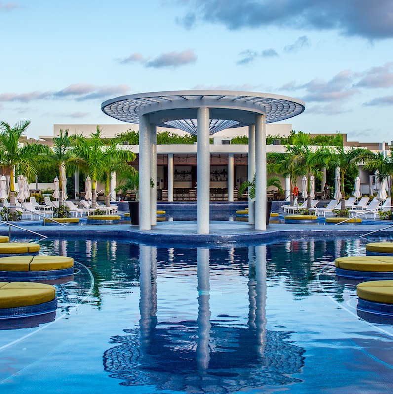 Cancun, Mexico – March 19, 2018: Main adult pool at the Unique Day Club, at the Grand at Moon Palace Cancun, a beautiful tropical Resort and Spa near Cancun, Mexico.