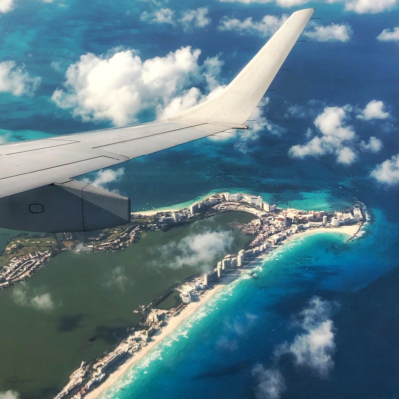 Airplane flying over Cancun