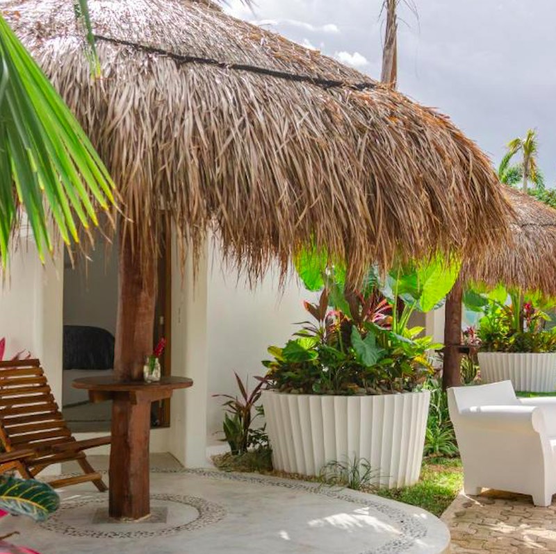 exterior of room and palapa at Tsaakik Jungle Hotel and Spa by Cancun International Airport