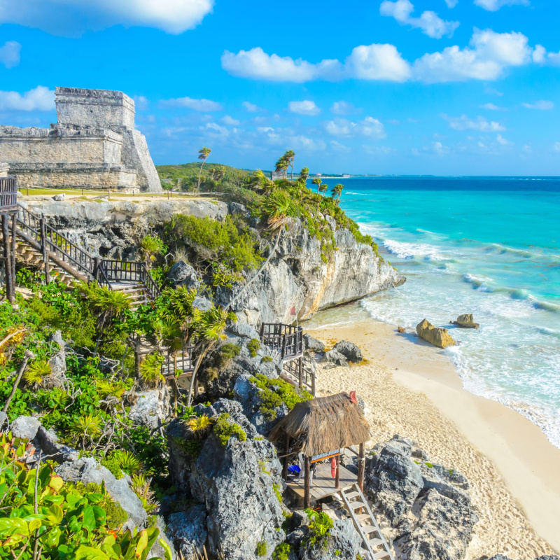 Tulum ruins and the beach and the turquoise Caribbean Sea.