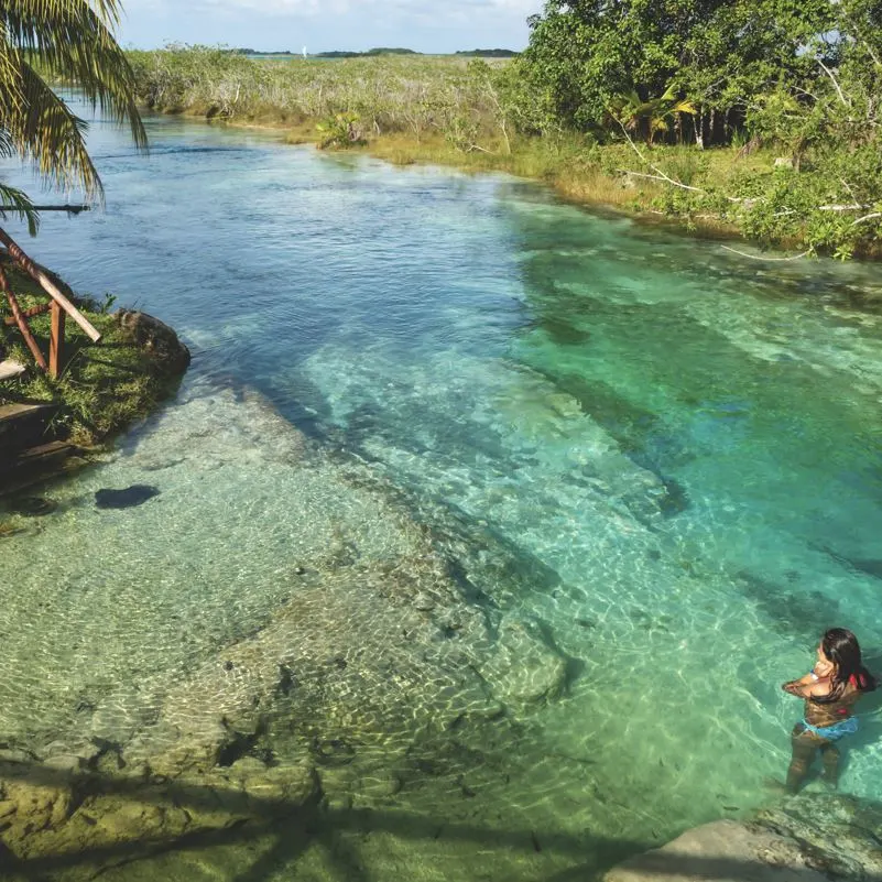 woman in clear water Bacalar lagoon