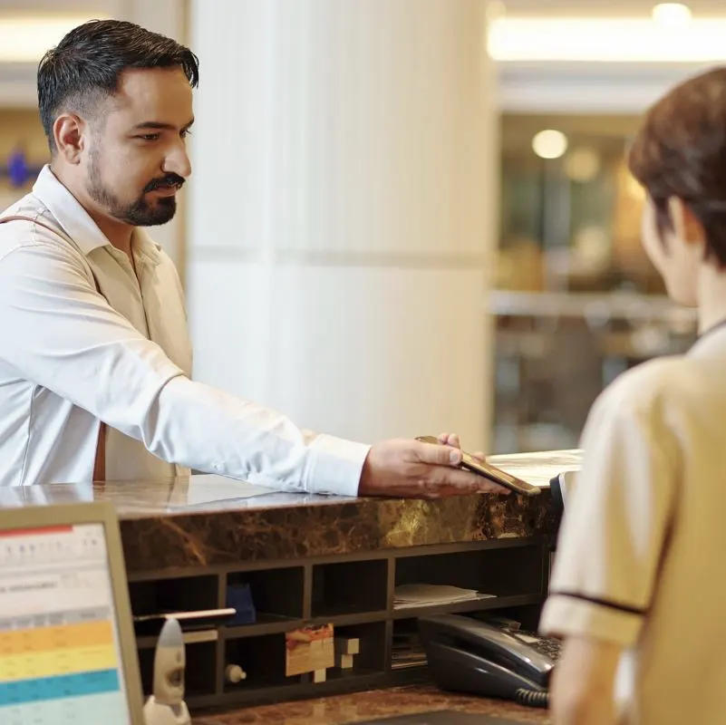 man logging complaint at cancun hotel front desk