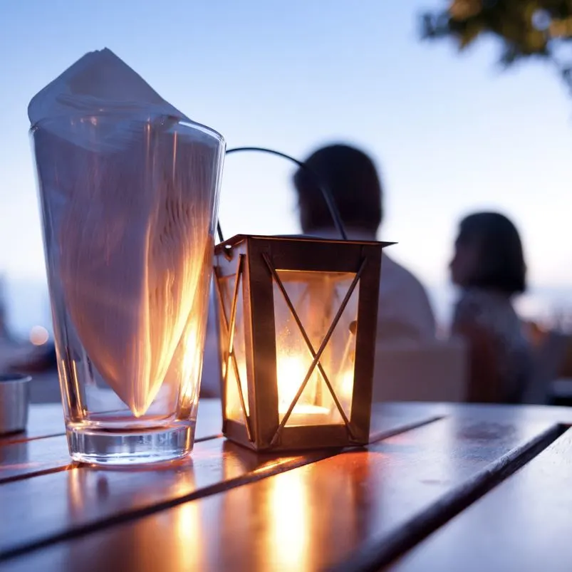 couple outdoor candle-lit dinner table

