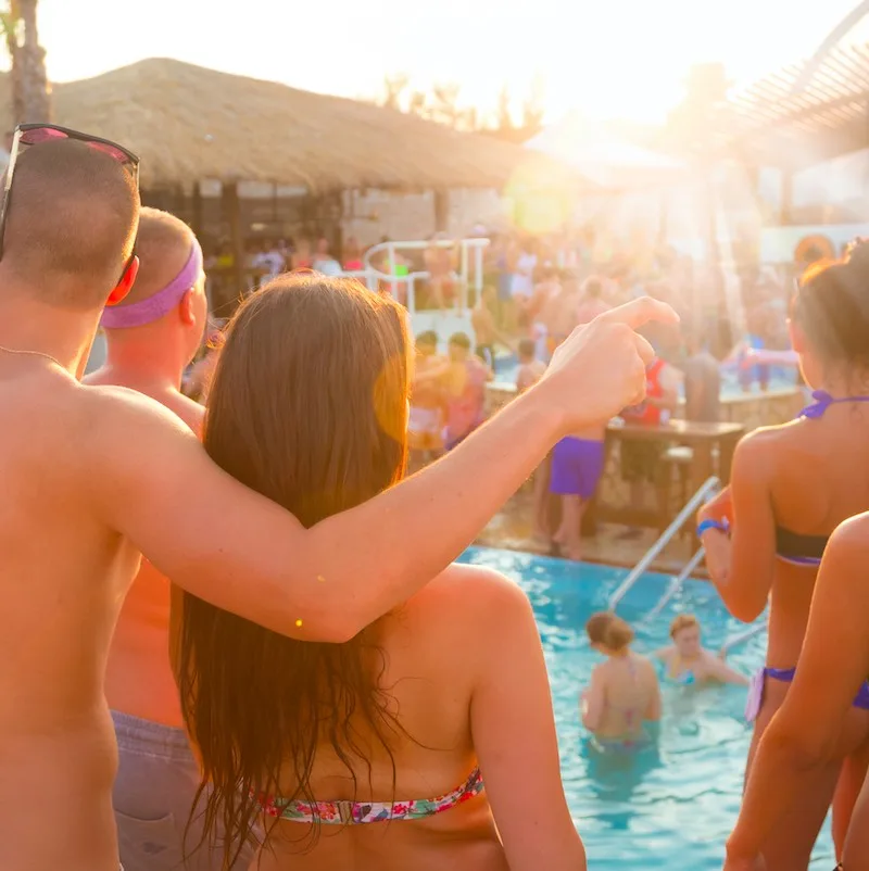 friends partying at music festival by the pool