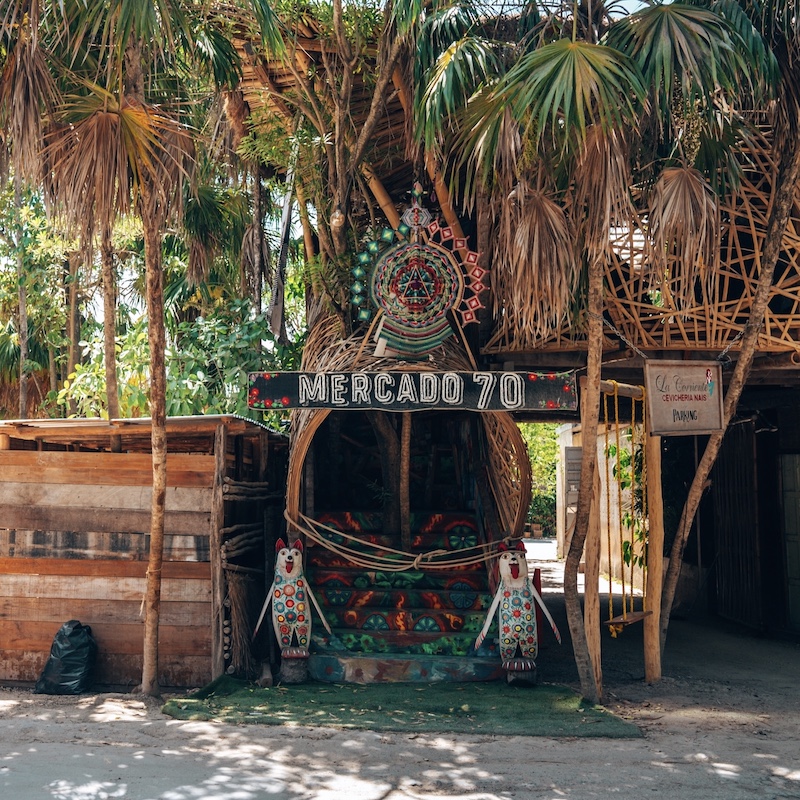 An authentic Tulum bar with palm trees 