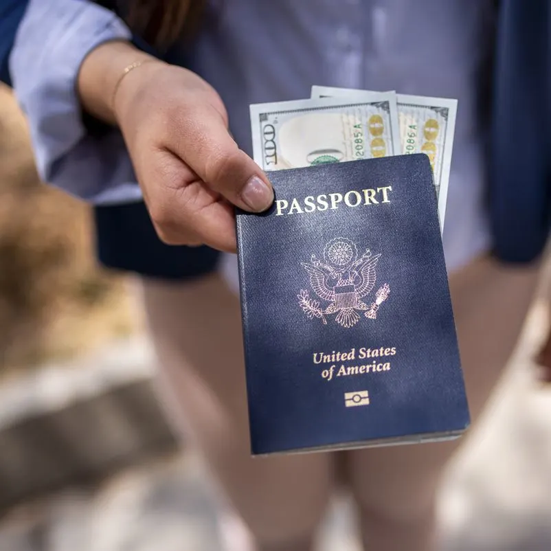 A traveler ready to visit a new country with u.s dollars