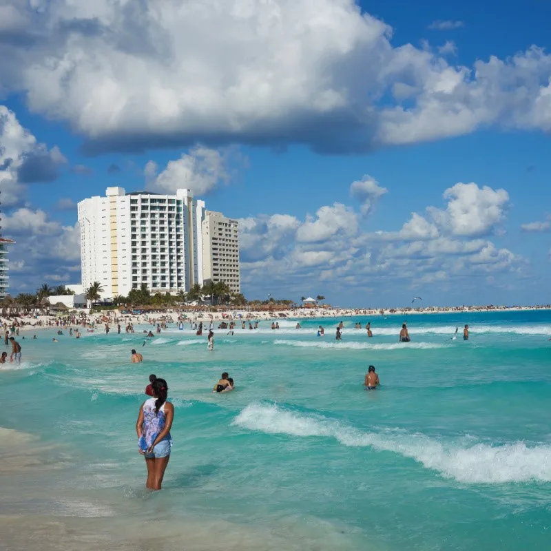 Beach in Cancun Hotel Zone with tourists in the water