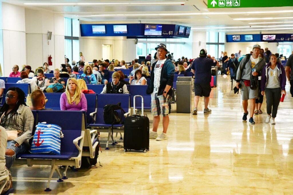 Busy Cancun Airport with Travelers Walking Around and Waiting