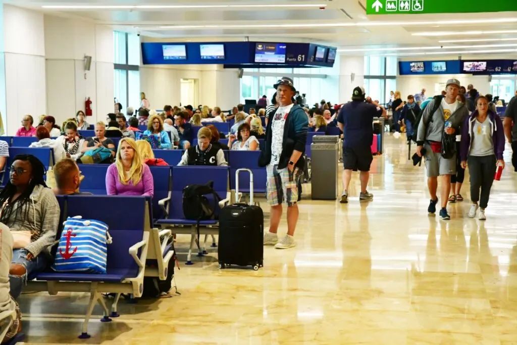 Busy Cancun Airport with Travelers Walking Around and Waiting