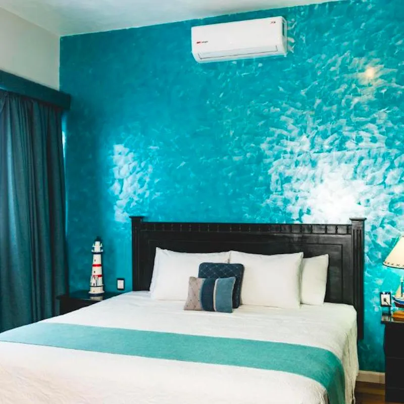 hotel room with tiled turquoise-colored wall at Casa Barco Hotel Boutique in Isla Mujeres.