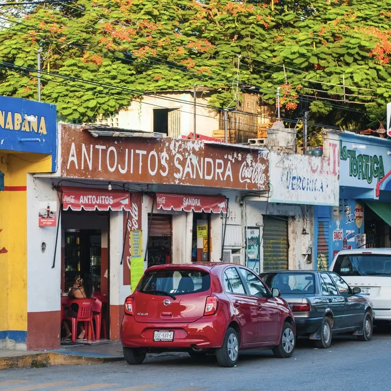 Corner street cars and colorful store