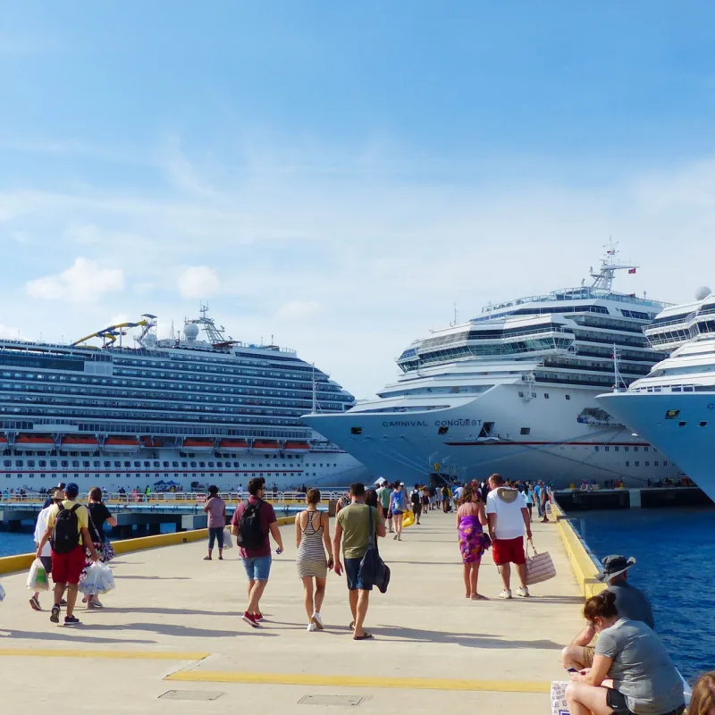 Cozumel cruises tourist walking back to ship with shopping bags on sunny day