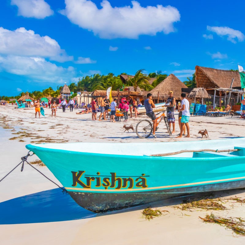 Boats moor along sunny Isla Holbox, Mexico's Caribbean main beach.