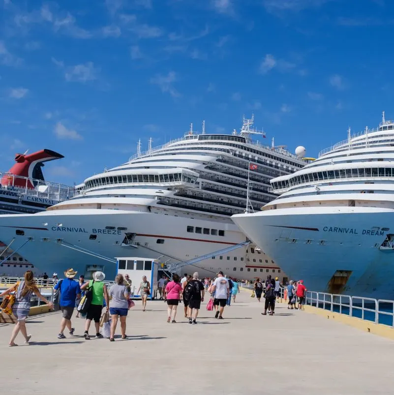 People walking along pier to cruise ships in cozumel, mexico