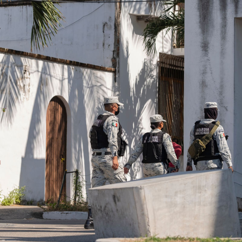 Playa del Carmen troops walking down the street in uniform.