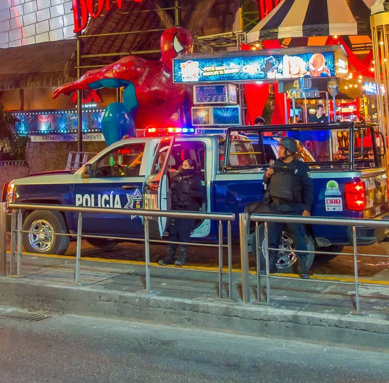 Police on Cancun Street in front of bars and restaurants.