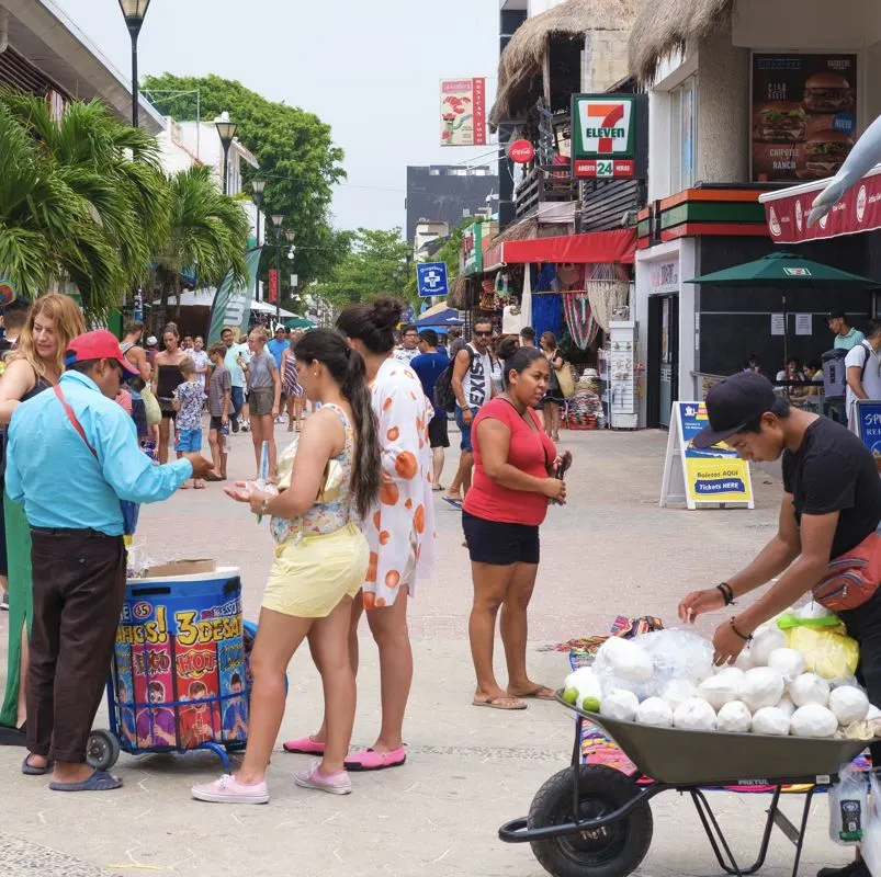tourists purchasing from street vendor
