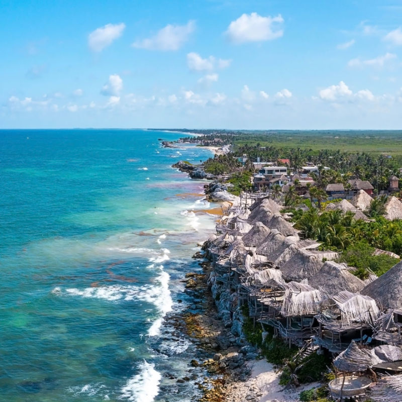 Aerial view of Tulum with blue water and resorts