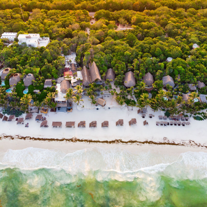 Tropical beach in Tulum with resort