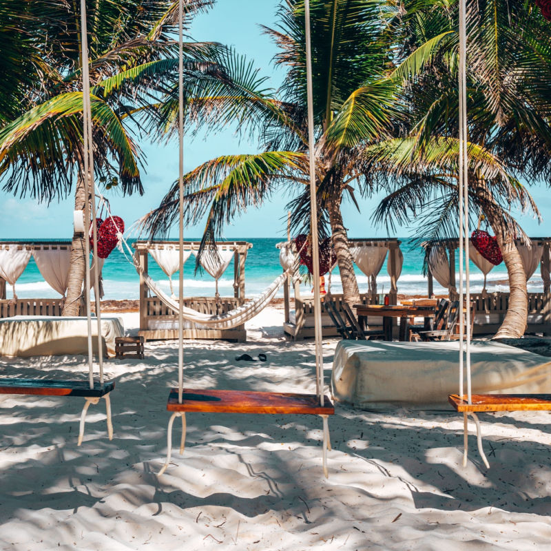 Outdoor area of a Tulum resort with swings