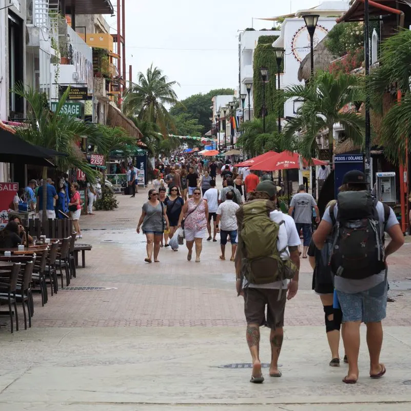 expats walking in a crowd on the streets in playa del carmen
