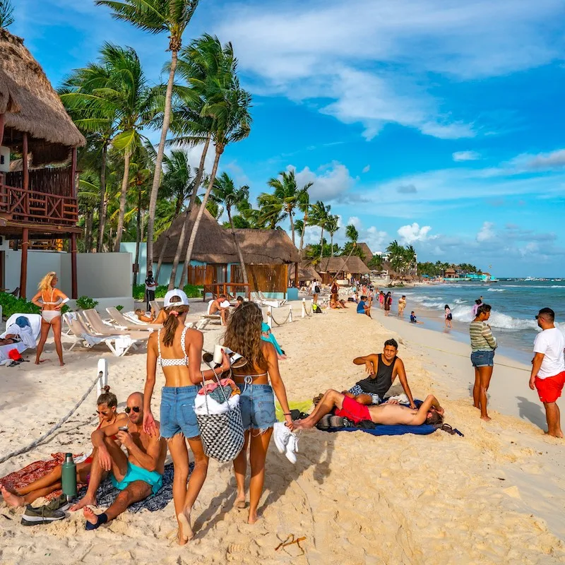 People on the beach in Playa del Carmen. The city boasts a wide array of tourist activities due to its geographical location in the Riviera Maya.