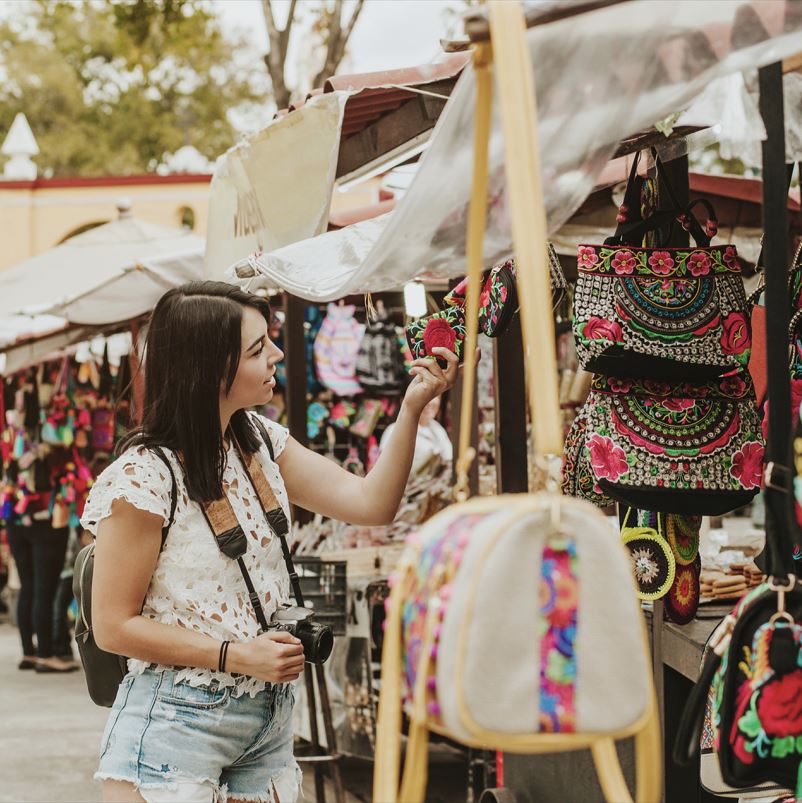 traveling girl shopping on local street