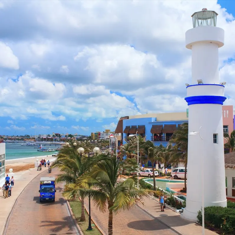 White lighthouse in cozumel tourist walking on street