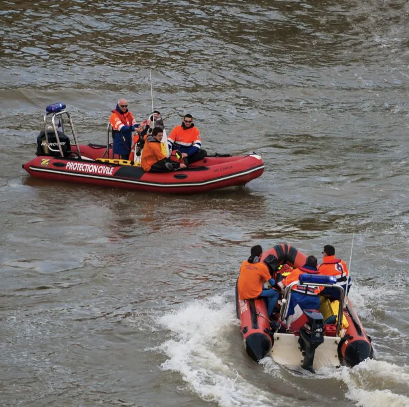 2 groups of search and rescue water police on speed boat on river