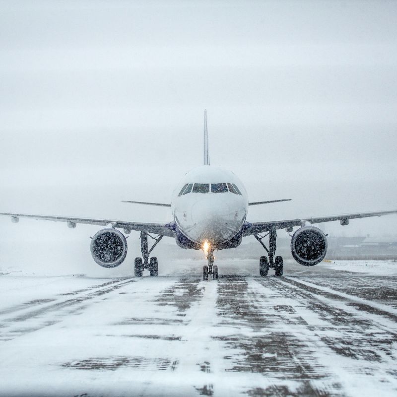 Airplane on runway in blizzard