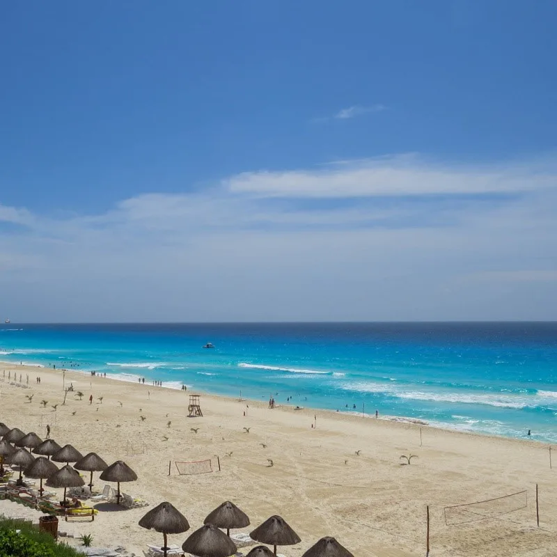 Empty Cancun Beach with white sand beach and turquoise blue water.